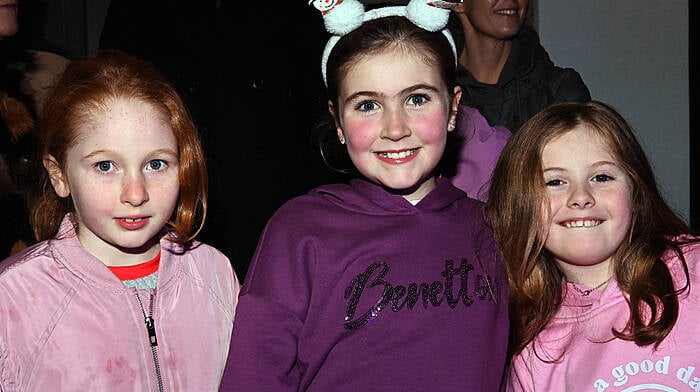 Local girls Amy Griffin, Rosie Harte and Phoebe Barry at the switching on of the Christmas lights, carol singing and Santa’s arrival in Timoleague on Sunday evening last.  Photo: Martin Walsh.