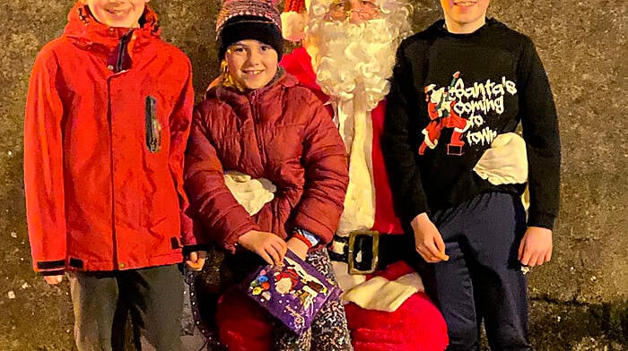 The Deasy family Liam, Maeve and Henry with Santa in Ballineen on Sunday evening.