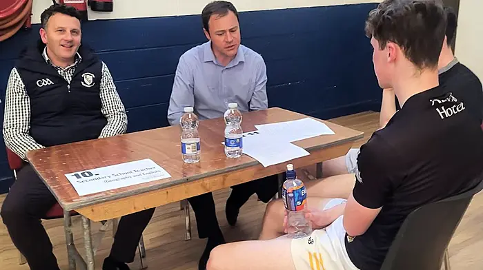 Some students chatting with, and getting advice from two Bandon GAA Club members Niall O'Rourke (secondary school teacher at Clonakilty Community College) and Rob Daly (mechanical engineer) at the recent careers night initiative organised by the Bandon GAA Club.
