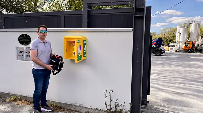 Michael Keohane of Keohanes Readymix Ltd placing the defibrillator into the AED unit at their premises in Enniskeane.