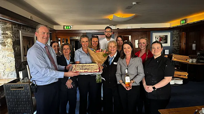 Norma Collins with her colleagues from the Trident Hotel at a celebration where Norma was rewarded for 25 years of unbroken service at the hotel.