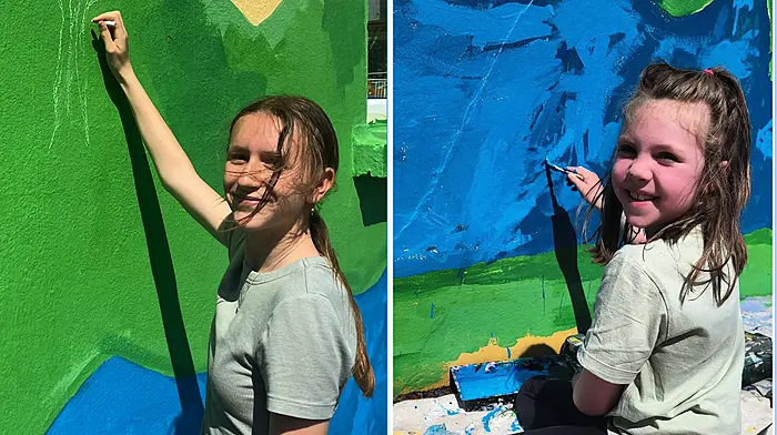 Small school, big mural,  big smiles, bigger hearts Image