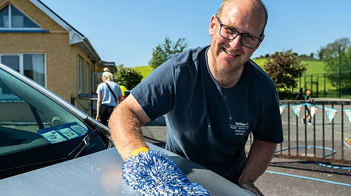 Skibbereen, West Cork, Ireland. 10th May, 2025. The warm weather continues in West Cork. Abbeystrewry National School held a charity car wash today, raising money for school funds. Volunteering his services for the day was Andrew Sweetnam from Skibbereen. Picture: Andy Gibson.