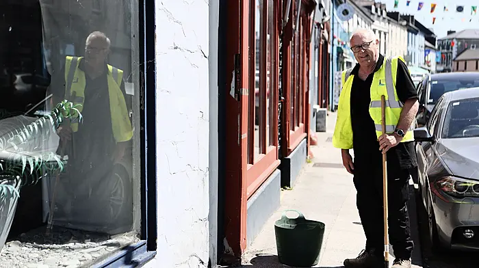 John Walsh, a member of Schull Tidy Towns, has been busy cleaning the Main Street pavement in preparation for this week’s Fastnet Film Festival.  (Photo: Carlos Benlayo)