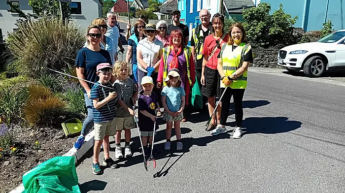 Maura Allen on Pier Road surrounded by her band of civic-minded helpers last Saturday as they cleaned up the village in preparation for the Fastnet Film Festival visitors.