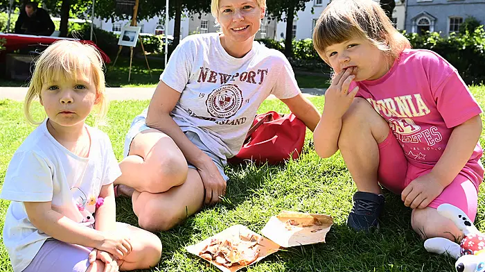 Mary Ward from Clonakilty with her twin daughters Ameilia (left) and Alice Burns, who are enjoying some food in Kennedy Gardens on a sunny day. (Photo: Martin Walsh)
