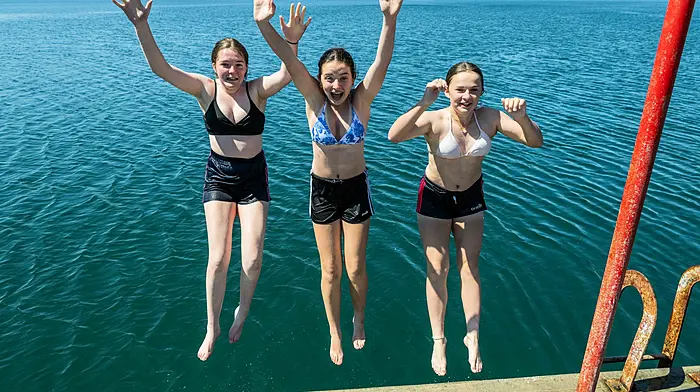 Sophie O'Donnell, Kasey Cotter and Callie O'Donoghue, all from Bantry, having fun in the sun and cooling off by jumping into the sea. (Photo: Andy Gibson)