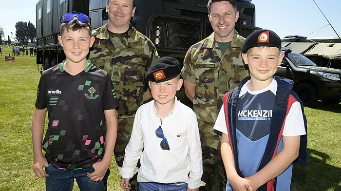 Darragh, Micheál and Cathal Gleeson from Skibbereen with Reserve Defence Force members Trevar Sheehan and Humphrey Lynch at the agricultural show in Bandon.   (Photo: Denis Boyle)