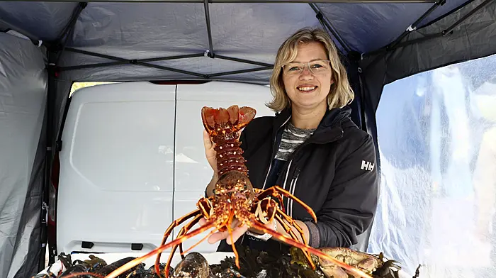Evie Bokuma selling fresh lobster and crabs at Sunday market in Schull. (Photo: Carlos Benlayo)