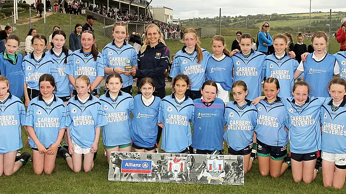 Roinn 2 Girls winners St Mary's Senior School Dunmanway receive the trophy from Cork footballer Laura O'Mahony. (Photo: Paddy Feen)
