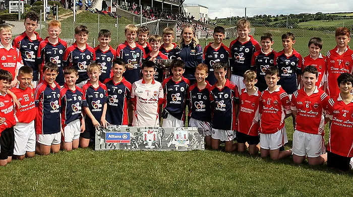 Roinn 1 Boys winners St Patrick's Boys NS Skibbereen receive the trophy from Cork footballer Laura O'Mahony.
(Photos: Paddy Feen)