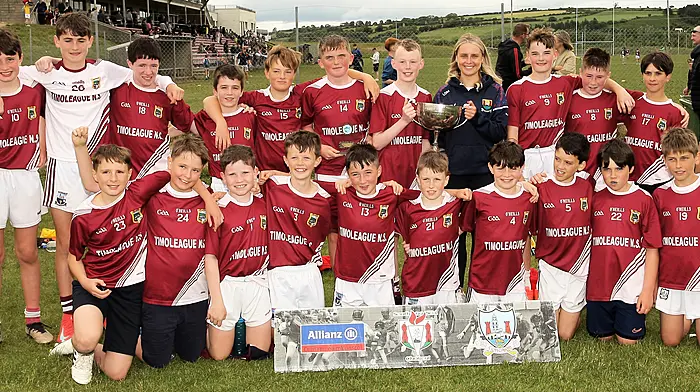 Timoleague NS, Roinn 2 Boys winners, receive the trophy from Cork footballer Laura O'Mahony.