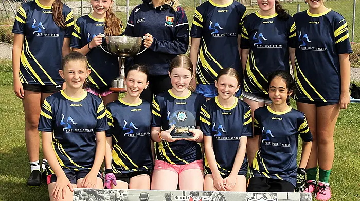 Roinn 5 Girls winners Tirelton NS receive the trophy from Cork footballer Laura O'Mahony. (Photo: Paddy Feen)