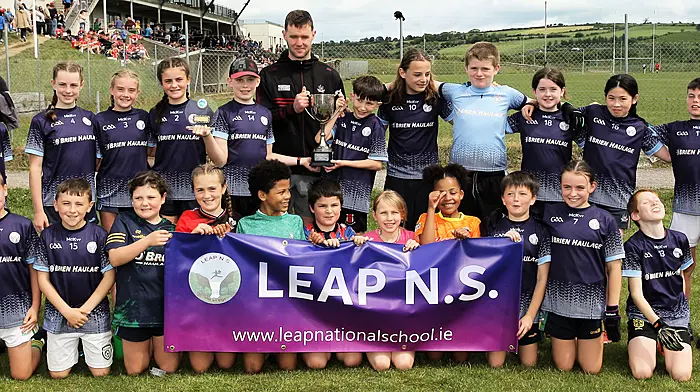 Roinn 9 Mixed winners Leap NS receive the trophy from Cork footballer Maurice Shanley. (Photo: Paddy Feen)