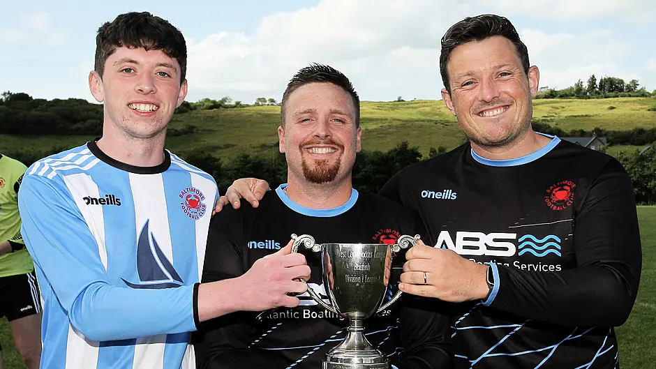 Baltimore FC's Barry Collins, captain Kieran Lynch, and Dan MacEoin with the O'Brien Water Services West Cork League Championship title that presented to the club at the Baltimore Road. (Photo: Paddy Feen)