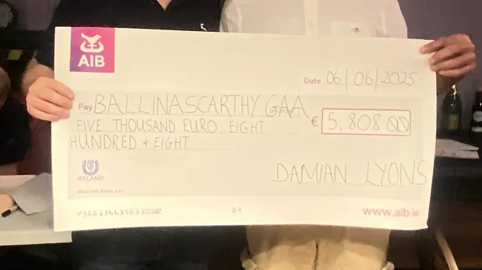 Damien Lyons presenting his winners cheque of €5,808 to Ballinascarthy GAA chairperson, Michael Ryan.