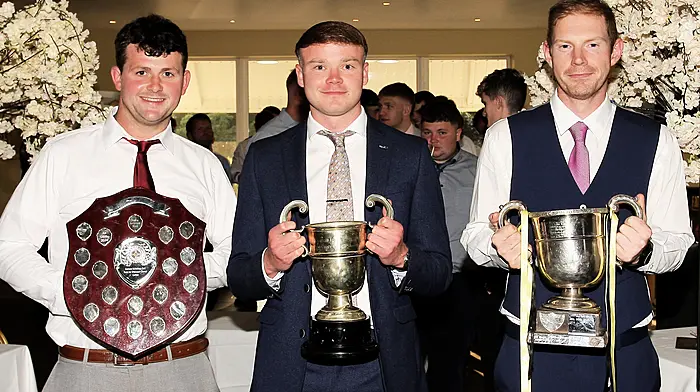 Leading the team parade to the function room with the three trophies won last year were, Tadhg Cullinane, Padraig Reidy and Ronan Kennedy.