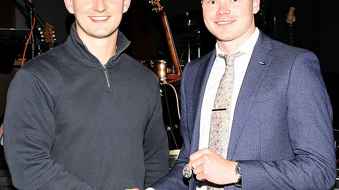 Special guest and Cork senior hurler Shane Kingston presents the team captain Padraig Reidy with his county medal.