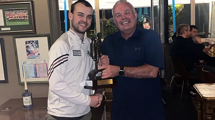 Colin Farr presenting the club classic GUI winning team captain Declan O'Shea with Doheny/Sam Maguire annual golf classic trophy.