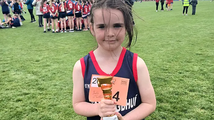 Indie O'Sullivan of Carrigboy National School with the trophy she won at Cork City Sports last week.