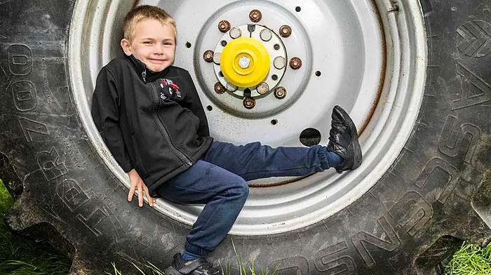 Lyre, West Cork, Ireland. 22nd Jun, 2025. A charity Tractor, Truck, Car and Motorcycle Run was held in Lyre, West Cork today. The run was in aid of Knockskeagh National School; Cancer Connect - West Cork and West Cork Rapid Response. Relaxing on his dad's tractor wheel was 6 year old Tommy Collins from Lyre. Picture: Andy Gibson.