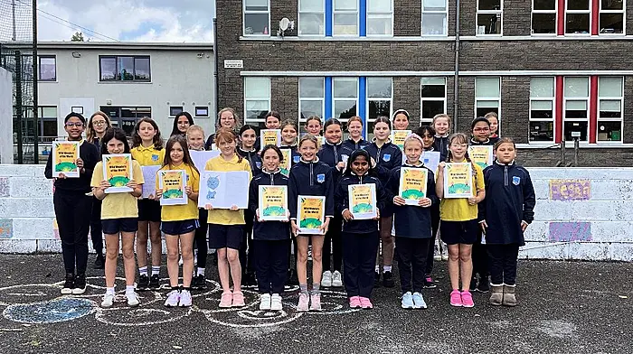 The fourth class students at Bandon Primary School proudly displaying copies of their first self-published book, Wild Wonders of the World.