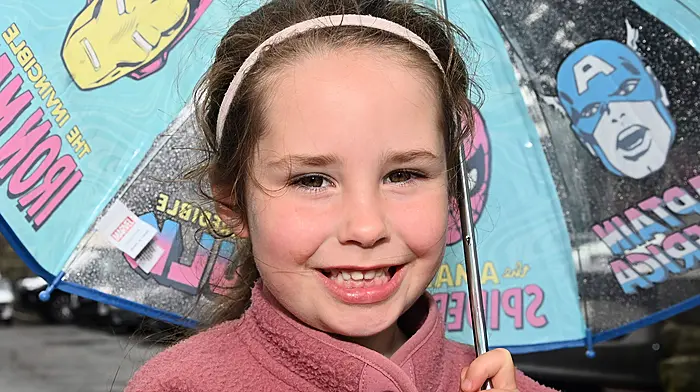 Local girl Kai Dawson was sheltered from the rain in Clonakilty last Friday. (Photo: Martin Walsh)