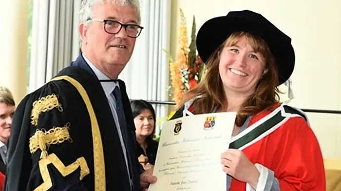 Natasha Dukelow of Ardogeena being conferred with her PhD by the president of UCC, Prof John O'Halloran. Natasha had undertaken her PhD at the UCC school of history where her thesis focused on a 13th century preaching text known as the Liber Exemplorum.