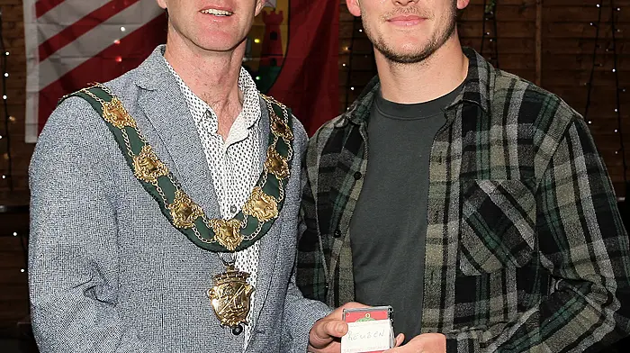 Mayor of Clonakilty Conan O'Donovan presents medals to the Clonakilty Soccer Club captain Reuben Henry.