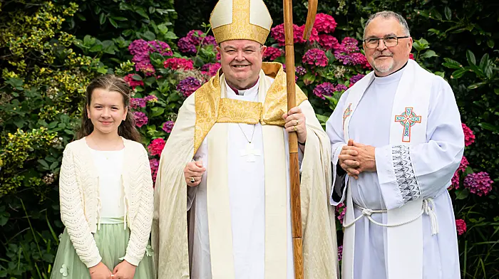 Sarah Dukelow of Durrus with Bishop Paul Colton and Canon Paul Willoughby after she received her confirmation.