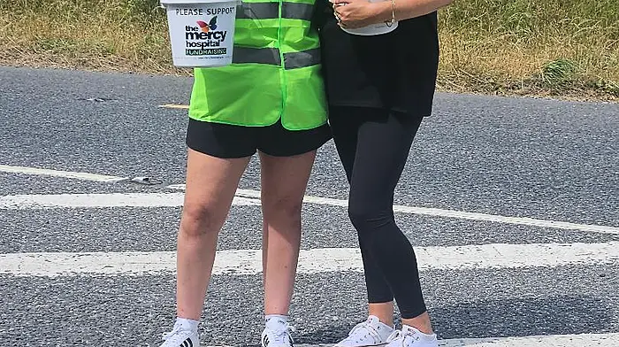Audrey O’Mahony and Erin Kelleher, volunteers at the bucket collection in Innishannon during the Make your Mark on Cancer charity walk.