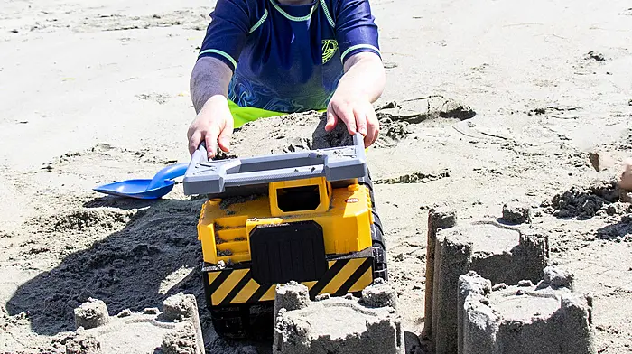 Mathew McCaughy using earth moving equipment to help him build his sandcastles on the beach at Keelbeg during the hot weather.  (Photo: Andrew Harris)
