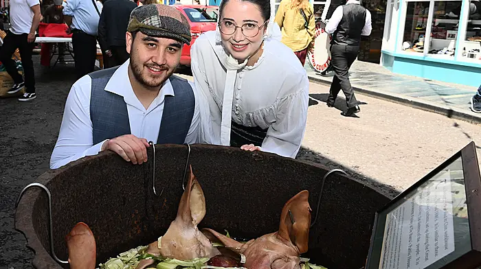 Locals Brian Shanley and Kym O'Connor having a close up look at pig’s heads and cabbage at the Old Time Fair in Clonakilty.  (Photo: Martin Walsh)