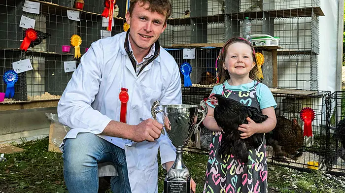 Three-year-old Katie Stafford from Rosscarbery with judge Darren Keohane at the annual Dunmanway Agricultural Show last Sunday where Katie won first place with her Pecan Hen in the poultry junior category.   (Photo: Andy Gibson)