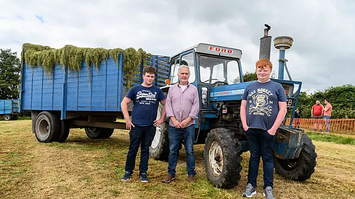 Jack, John and Cathal Tobin (The Pike) with their 1975 Ford 7000 which has been drawing silage for the family for 50 years. It was drawing silage again at The West Cork Vintage Ploughing & Threshing Association’s vintage harvest day at The Pike, Clonakilty. Proceeds from the event will go to Down Syndrome Cork, Field Of Dreams, Marymount Hospice and Bandon AFC and GAA All-Stars.  (Photo: David Patterson)