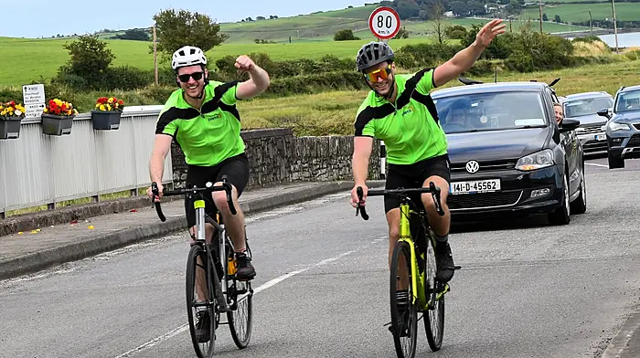 Ross and Niall O'Hanlon cycling over Church Bridge and entering Timoleague last Friday where they completed their memorial cycle.
