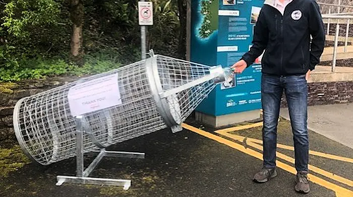 Darragh O'Shea admires one of the new recylcing bins provided Glengarrif Tidy Towns by the council.