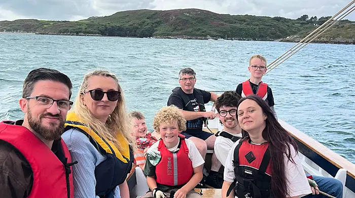 Cormac Levis steering his boat 'Saoirse Muireann' with passengers Simon Levis, Amy Harrison, Joseph Harrison O’Connor, Cormac Vickerton Levis, Ziggy Vickerton Cooley, Hugh Levis, and Grainne Browne at the boat gathering in Ballydehob.