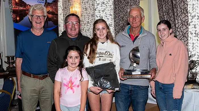 Schull Harbour Sailing Club Commodore Jack Allen (far left) was more than delighted to present Schull skipper of Witchcraft, Simon Nelson, the trophy for an overall win of Class 4 at the end of Calves Week.  It was a great achievement for Simon and his crew, Pat Coughlan and daughters Freya (left) and Annie.  The youngest Coughlan, Tierna, was chief cheerleader for the day.