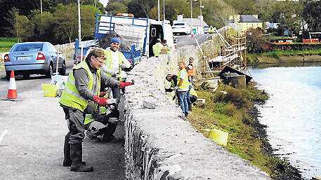 Stonemasons repair three-arch bridge Image