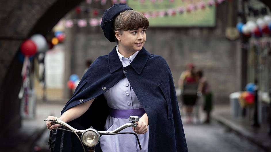 Finding the right sized bike for Megan proved a bit of a challenge for the crew!  She’s happy that lots of her scenes now see her with her feet firmly on the ground. ‘Were people really tall back then? I don’t know,’ she says.  					                   (Photo: BBC/Neal Street Productions)