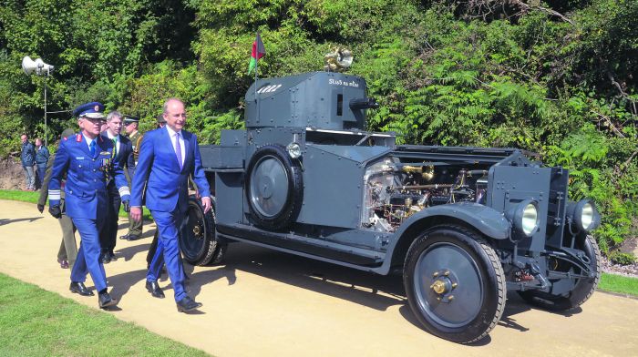 Taoiseach Micheál Martin passing the original Sliabh na mBan armoured car which followed Michael Collins’ touring car on August 22nd 1922 to Béal na Bláth. The car was on loan on Sunday from the Curragh camp in Kildare.       (Photo: Denis Boyle)