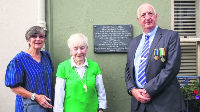 General Michael Collins visited No 6, the Square, Rosscarbery, hours before he died at Béal na Bláth. He was visitng the McDonald family, and this week a plaque was unveiled at the site, in his memory, by the local history society. Anne Outram  and Maeve Smith, above, unveiled the plaque with Don Healy, chairman of Rosscarbery & District Historical Society.		               									                   (Photo: George Maguire)