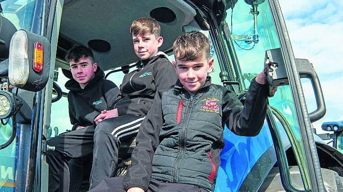 Brothers  Jonathan, Stephen and Mathew O'Neill from Skibbereen on their New Holland. (Photo: Denis Boyle)