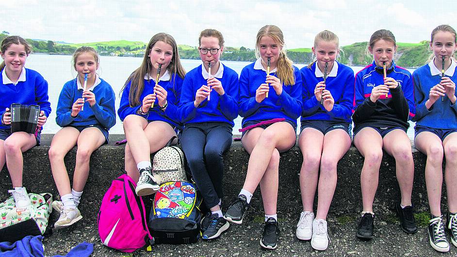 Sixth class pupils from Castletownshend NS Ciara O’Shea, Mary O’Driscoll, Izzy Cahalane, Aoife Courtney, Aoife McCarthy, Lauren O’Callaghan, Kerri McAuliffe and Lilly Bowe entertaining crowds attending a launch by Castlehaven-Myross History Society of a ‘Blue Way’ between two rocks in the harbour named ‘Dominie O’Coilean’ and ‘Red Hugh’s Rock.’ 										     (Photo: Andrew Harris)