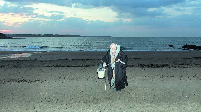 Priest cleans up unholy beach mess Image