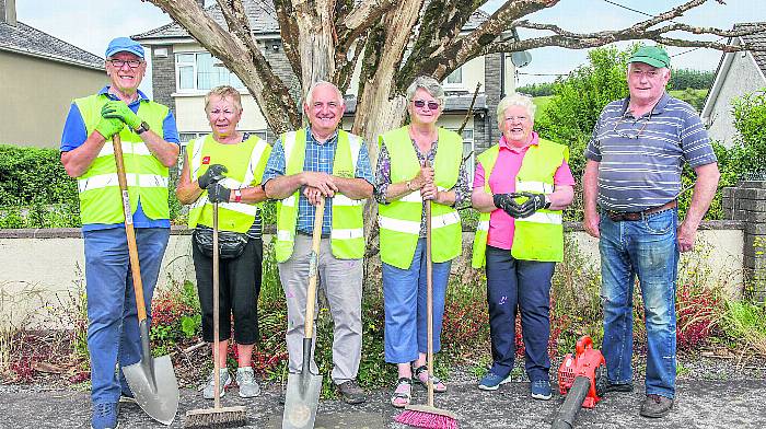 Members of Croí na Laoi Inchigeelagh Tidy Towns taking a short break from working on sprucing up the village this week. From left: Andy Wells, Teresa Cotter, Tim Maher, Nora O’Riordan, Neasa Ní Laoire and Billy Cotter. 							       (Photo: David Creedon)