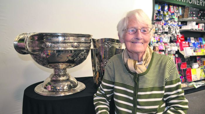 Chrissie Connolly from Skibbereen, seen with the Sam Maguire and Liam MacCarthy cups on display at Fields last weekend. (Photo: Anne Minihane)