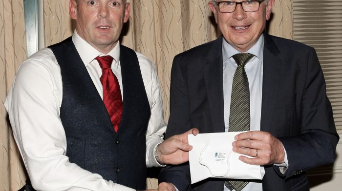 Paul O'Callaghan, treasurer of West Cork LGFA makes a presentation to the MC for the night Paudie Palmer.