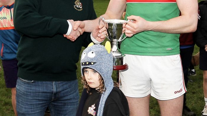 Mark Griffin, brother of the late Padraig Griffin, presents the Padraig Griffin Memorial Cup to Mark White captain of Team C.